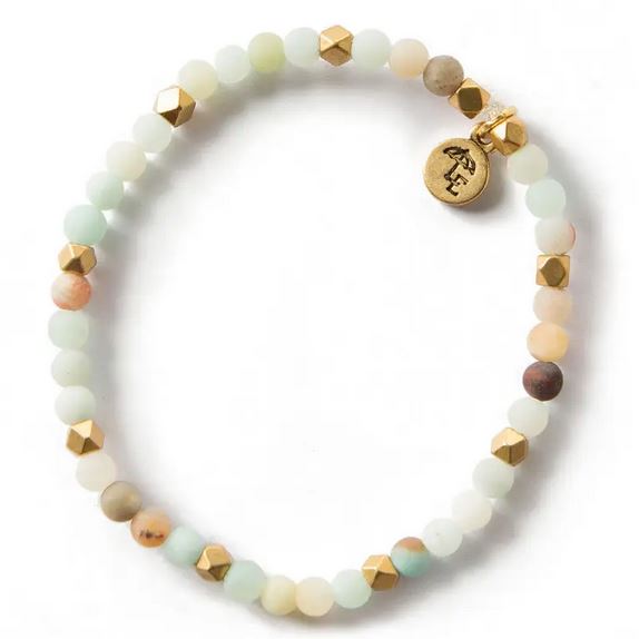 The Amazonite Gemstone Bracelet, 4mm by Lenny & Eva is a round beaded bracelet featuring natural semi-precious gemstones in white, pale green, and earthy tones. It is interspersed with small gold hexagonal beads and includes a small gold charm engraved with an initial or symbol near the clasp. With brass accents and an elegant, minimalist design, this bracelet stretches to fit most wrists.