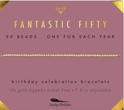 Set against a vibrant purple background, commemorate the milestone with our "50th Birthday" bracelet by LuckyFeather. This 14k gold-dipped accessory includes 50 beads, symbolizing each year, and is both nickel-free and adjustable (7-8 inches) for an ideal fit. It combines elegance with simplicity to create meaningful significance.