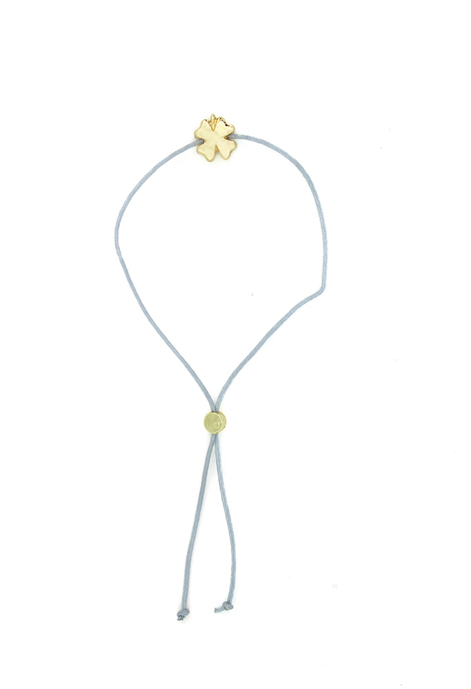 The Wish Birthday bracelet by LuckyFeather is a light blue accessory that showcases a gold flower-shaped charm at its center. It features an adjustable slide knot, adorned with a small round 14k gold bead.