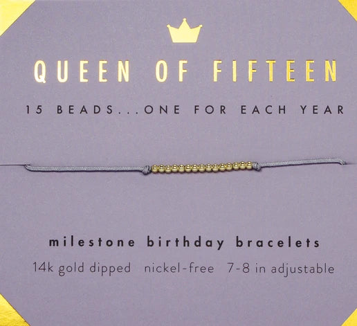 The "15th Birthday bracelet" by LuckyFeather features fifteen 14k gold-dipped beads on a purple card, each bead representing a special year. The card highlights the bracelet's nickel-free and adjustable design, encapsulating the essence of milestone jewelry with grace and elegance.