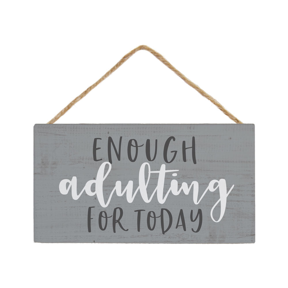 An exquisite SincereSurroundings piece called "Enough Adulting" showcases playful text in lively white and black fonts. The sign, crafted from muted gray wood, hangs elegantly by braided twine, adding charm to this delightful ornament.