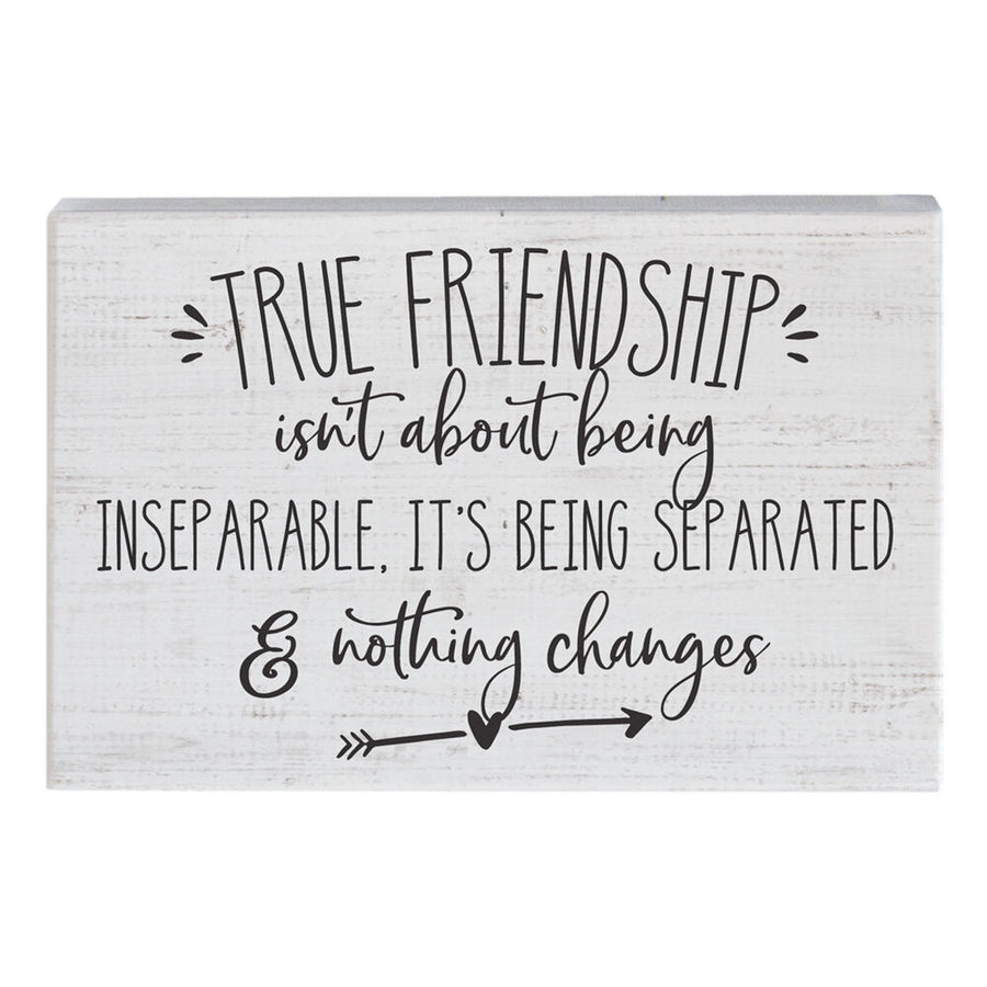 The "True Friendship" sign by SincereSurroundings is a handcrafted wooden piece featuring a whitewashed background and black text that reads, "True friendship isn't about being inseparable, it's being separated & nothing changes." Adorned with two arrows and small heart illustrations, it offers an easy display of heartfelt sentiment.