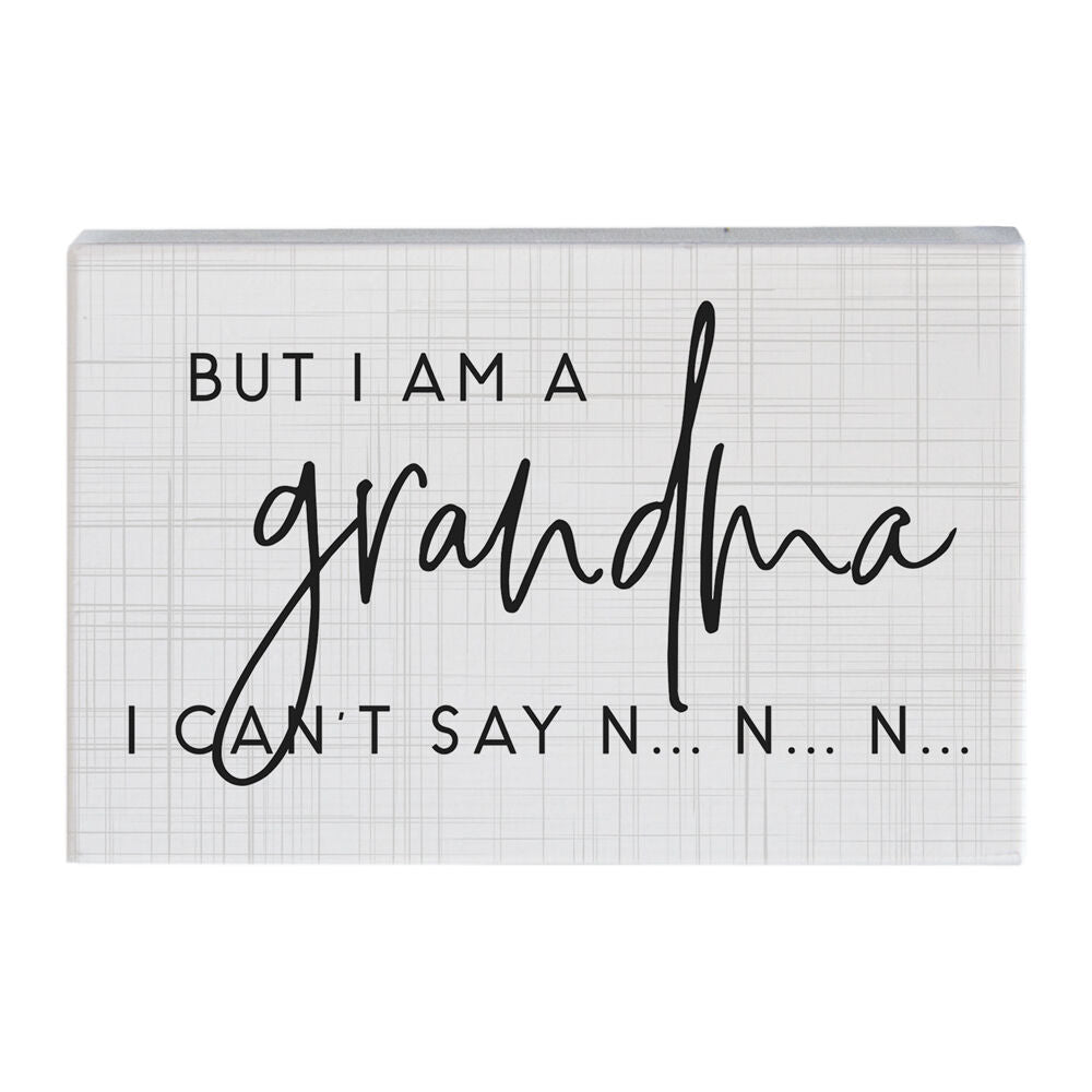 Introducing "Cant Say No" by SincereSurroundings: a handcrafted decorative sign featuring a white background adorned with subtle gray lines. The sign displays the text "BUT I AM A grandma I CAN'T SAY N...N...N..." in an elegant blend of uppercase and cursive fonts, making it an ideal addition to the cozy atmosphere of your Rock Rapids home.