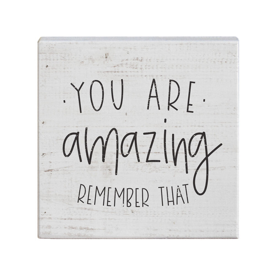 The "You Are Amazing" sign from SincereSurroundings is a charming handcrafted white wooden decor piece boasting a rustic texture and features the text "YOU ARE amazing REMEMBER THAT" in black, handwritten-style font. Its easy display makes it a delightful addition to any room.