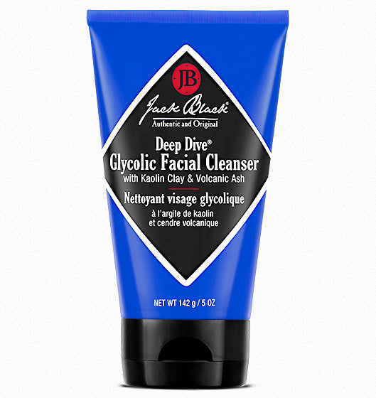 A blue tube of Deep Dive Glycolic Facial Cleanser from Jack Black, featuring a black and white diamond-shaped label. Infused with Glycolic Acid, it contains Kaolin Clay & Volcanic Ash and is available in 142 grams or 5 ounces.