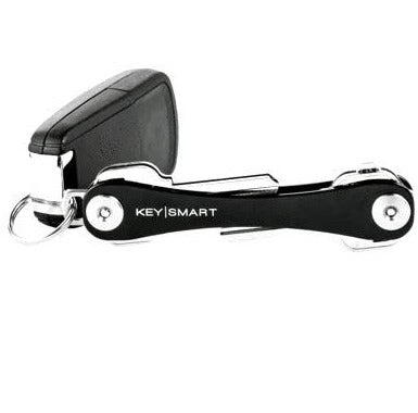 The KeySmart Key Holder, a compact black and silver organizer from KeySmart, efficiently maximizes pocket space while neatly accommodating several keys, including a sleek black car key fob.