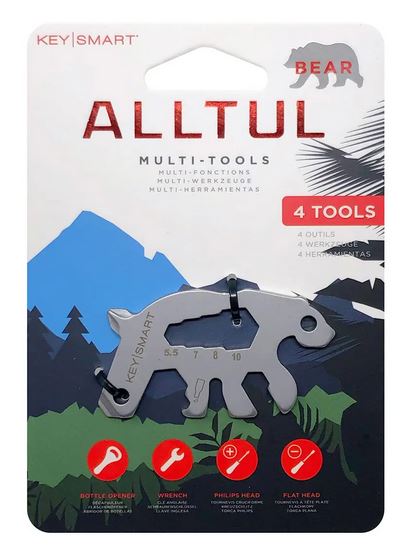 Packaging for the Bear Keychain Multitool by KeySmart, shaped like a bear. This versatile outdoor tool features a bottle opener, wrench, Phillips head screwdriver, and flat head screwdriver. The lightweight durability is perfect for adventures. The background has a mountain design and a description in multiple languages.