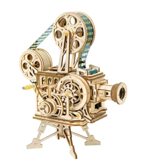 The DIY Vitascope by Hands Craft is a detailed, laser-cut wooden model of a vintage film projector. This 3D puzzle features intricate gears and reels with a strip resembling film passing through it, all showcased on a tripod-style base that highlights its exceptional craftsmanship and design.