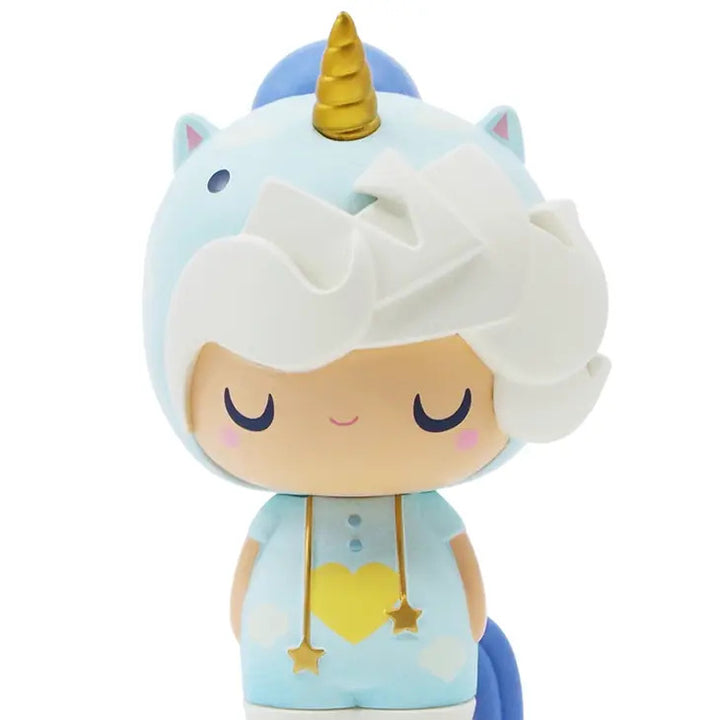 The Little Starlight Girl by Momiji is an adorable miniature vinyl doll dressed in a blue and white unicorn outfit, complete with a golden horn and ears on the hood. Featuring a peaceful facial expression with eyes closed, this charming figure has a white, wavy hairstyle and is adorned with dangling star accents.