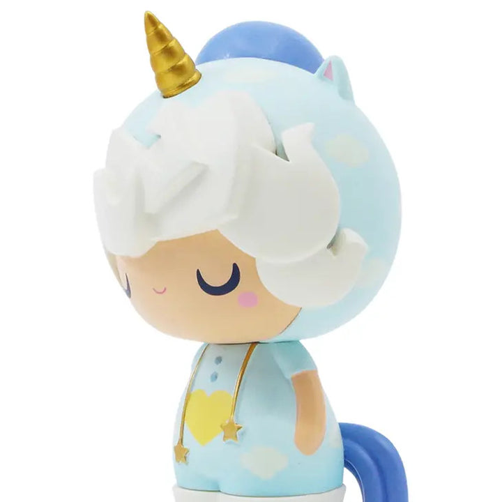 The Little Starlight Girl by Momiji is a cute cartoon-style vinyl doll of a chibi character in a blue unicorn costume. It features a golden horn, white hair, and a blue tail. The character has closed eyes, a small smile, and a heart on its chest with star decorations hanging from its neck. This adorable figure is the perfect unicorn guardian.