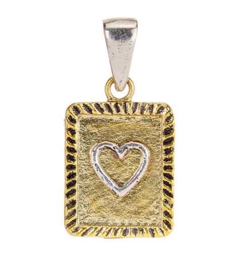 The Momento Charm - Heart by Waxing Poetic showcases a rectangular gold pendant adorned with a raised silver heart contour in the center, set against a brass background. It features an intricately textured border and understated black detailing, all highlighted by a sterling silver bail at the top.