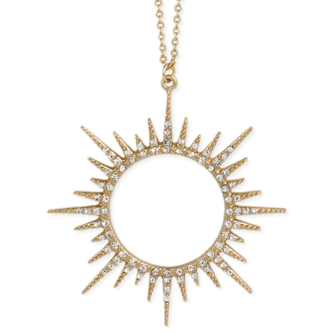 The Gold Sunburst Crystal Necklace by ZAD Jewelry features a circular sunburst pendant with radiating spikes adorned with small, sparkling crystals. The fine gold link chain appears delicate, perfectly complementing the intricate design of the pendant.