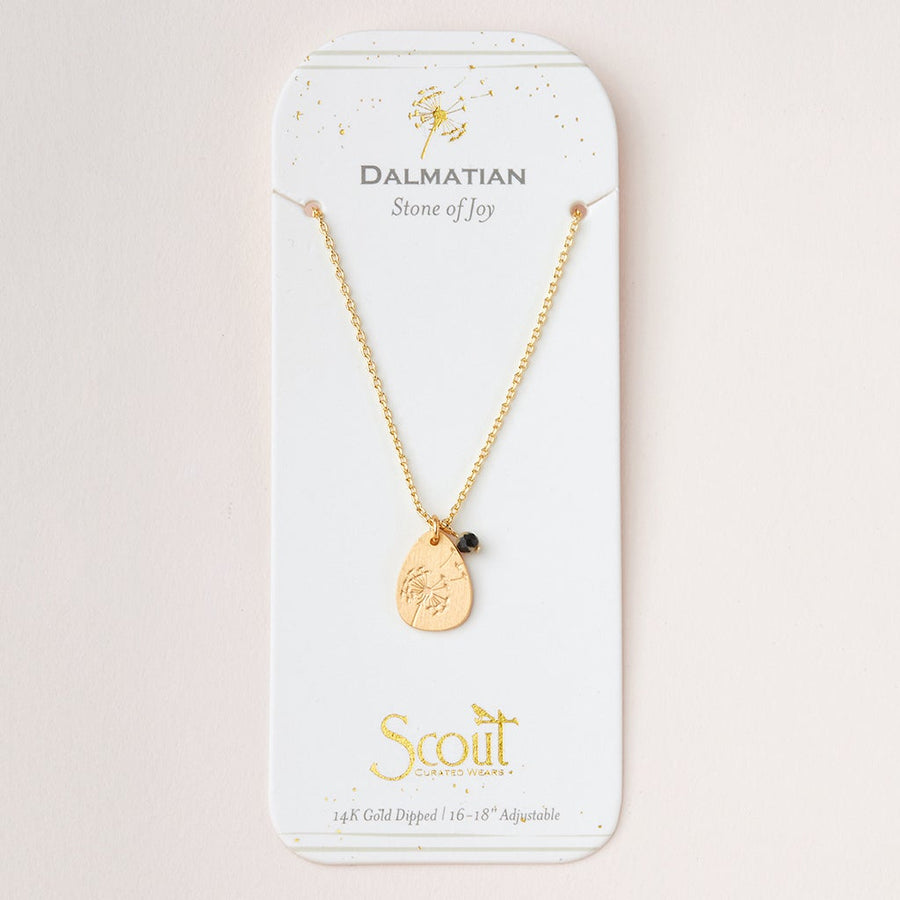 The Intention Neck Dalmatian/Gold by Scout Jewelry features a teardrop-shaped pendant with a small black bead on a 14K gold-dipped, adjustable 16-18'' chain. It reads "Dalmatian Stone of Joy" and "Scout Curated Wears," elegantly presented on a white card.