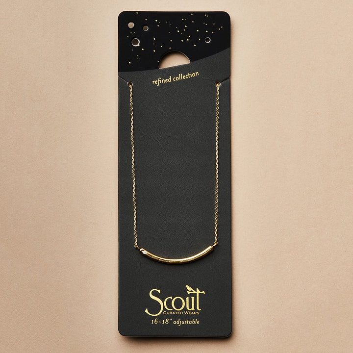 The "Refined Neck Comet/Gold" necklace from Scout Jewelry is elegantly displayed on a black card holder featuring the text "Scout Curated Wears" and "16-18'' adjustable." The starry design at the top complements the gold lettering of the refined collection name.