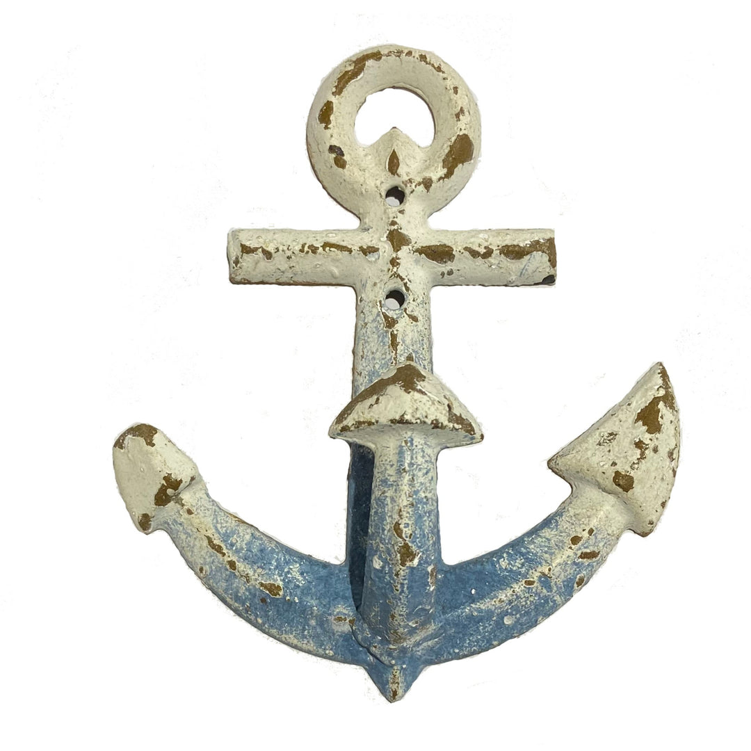 The 180Degrees Cast Iron Anchor Wall Hook, measuring 6 inches tall, boasts a rustic antique finish with weathered white and blue paint that peels away to reveal a worn texture. This decorative piece includes a loop at the top and traditional pointed ends.