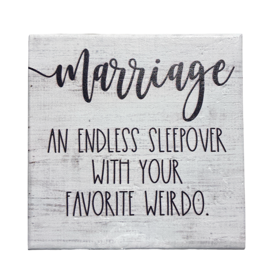 The SincereSurroundings "Marriage Endless" is a handcrafted decorative sign that features the text: "Marriage: An endless sleepover with your favorite weirdo" in black script on a white wooden background, making it perfect for easy display.