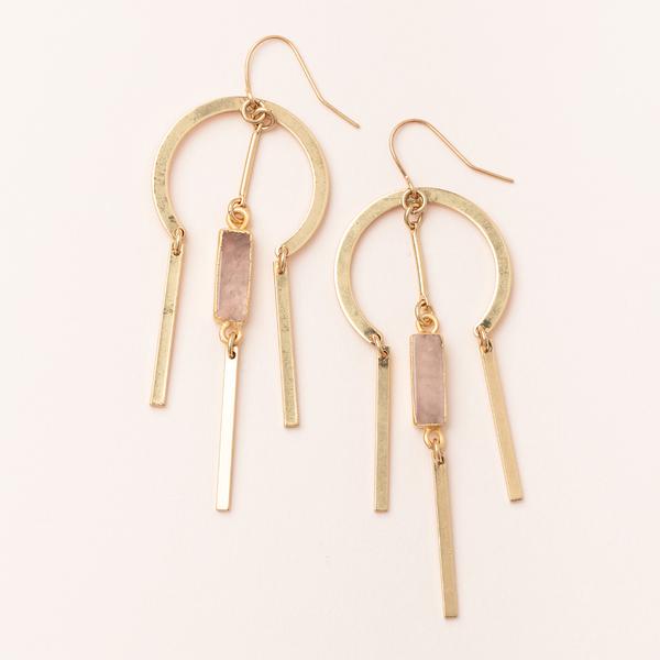 Introducing the Dreamcatcher Earring Rose Quartz Gold by Scout Jewelry: Exquisite gold dangle earrings featuring circular metal hoops adorned with three elongated rectangular bars hanging from each. These 14k gold earrings offer a minimalist design with an elegant flair, and are nickel and cadmium free, perfect for any occasion.