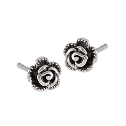 The Small Rose Silver Stud by Welman features a pair of sterling silver stud earrings designed in the shape of detailed roses. The intricately crafted petals and darkened center highlight the floral pattern, giving them a small, elegant, and classic appearance that is perfect for being mask-friendly.