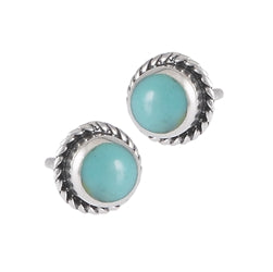 The Round Turquoise Roped Silver Stud by Welman showcases vibrant turquoise stones beautifully set in a twisted rope design, crafted from sterling silver. Their compact size makes them mask-friendly, bringing a subtle elegance to any outfit.