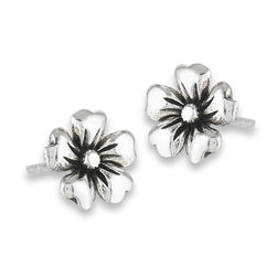 Introducing the Hibiscus Flower Silver Stud by Welman, made from sterling silver. These earrings feature five-petal flower shapes with a textured design and a central bead. The polished finish on the petals is accented by darker detail at their base, enhancing the floral look. Their face height makes them both mask-friendly and comfortable to wear.