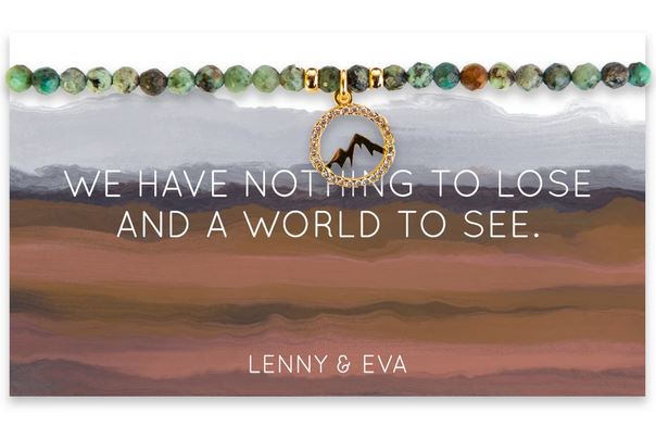 The Wanderlust Mountain Bracelet, featuring multicolored beads and a circular pendant with African turquoise gemstones, is presented on a card showcasing a scenic design with the words "We have nothing to lose and a world to see." by Lenny & Eva.