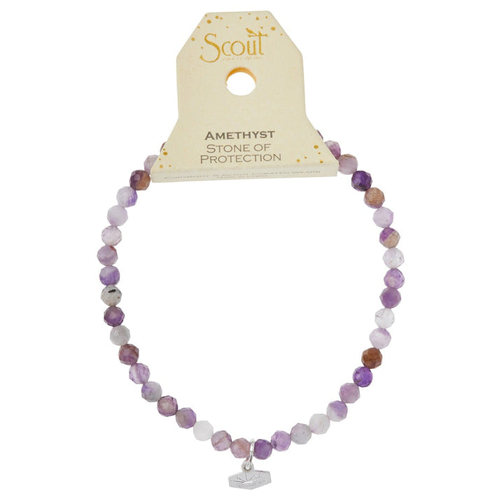 The "Mini Bracelet Amethyst/Silver" from Scout Jewelry is a stunning accessory, showcasing purple and brown faceted stone beads complemented by a silver charm. Its packaging highlights semi-precious gemstones, such as Amethyst—the Stone of Protection.