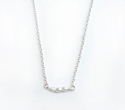 Presenting the "Teacher Pearls of Wisdom" by LuckyFeather: a delicate sterling silver necklace showcasing a slim chain and a central row of three small, faceted beads. This minimalist and sophisticated piece is perfect for adding meaningful elegance to any occasion.