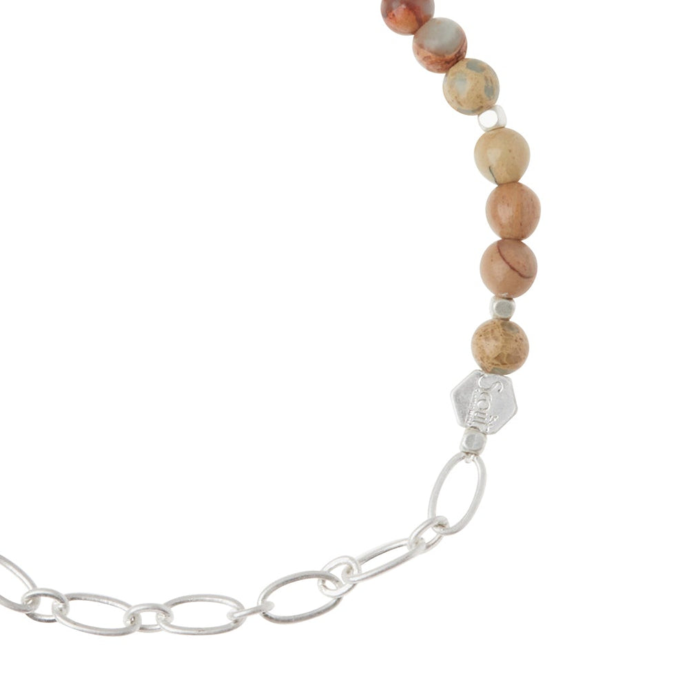 A bracelet from Scout Jewelry, called the Chain Bracelet Aqua Terra/Silver, showcases polished semi-precious gemstone beads that smoothly transition into a silver paperclip chain.