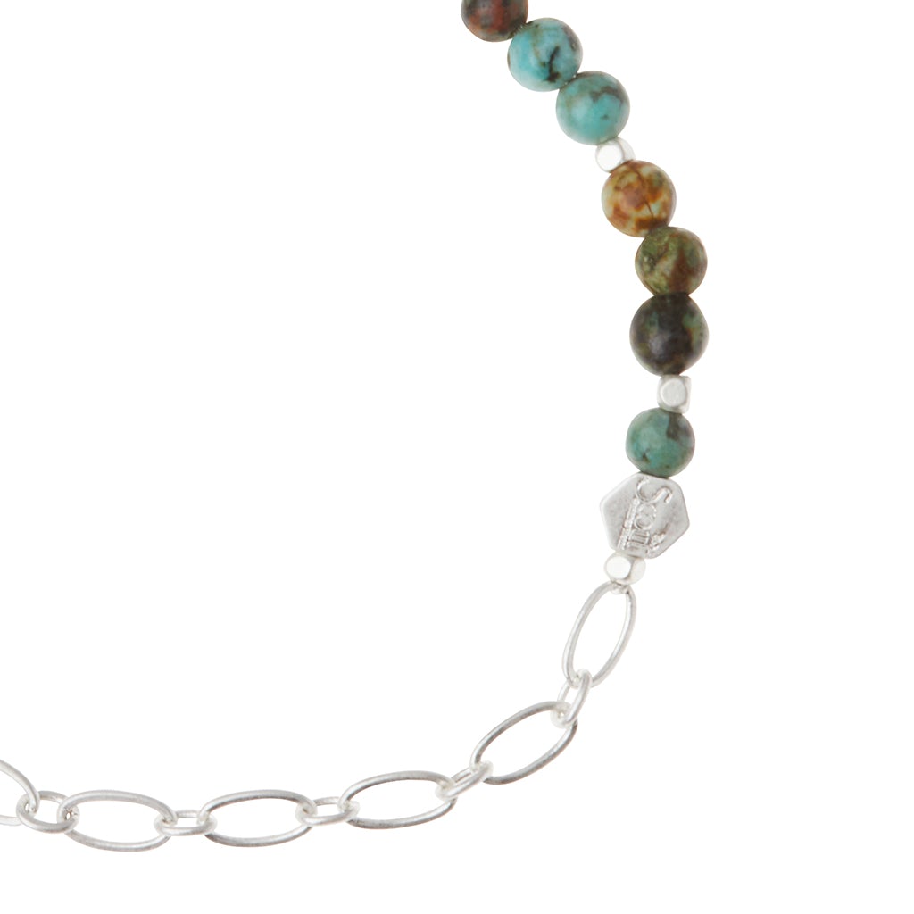 The Scout Jewelry "Chain Bracelet African Turq/Silver" elegantly blends polished turquoise and brown beads with an oval-linked silver paperclip chain.