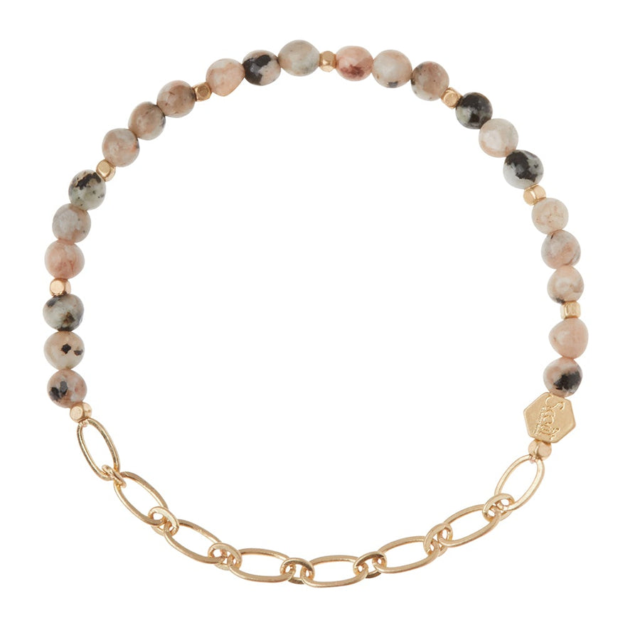 The Chain Bracelet Rhodonite/Gold by Scout Jewelry features round multicolored semi-precious gemstone beads in gray, pink, and black with gold oval paperclip chain links and a small engraved charm.