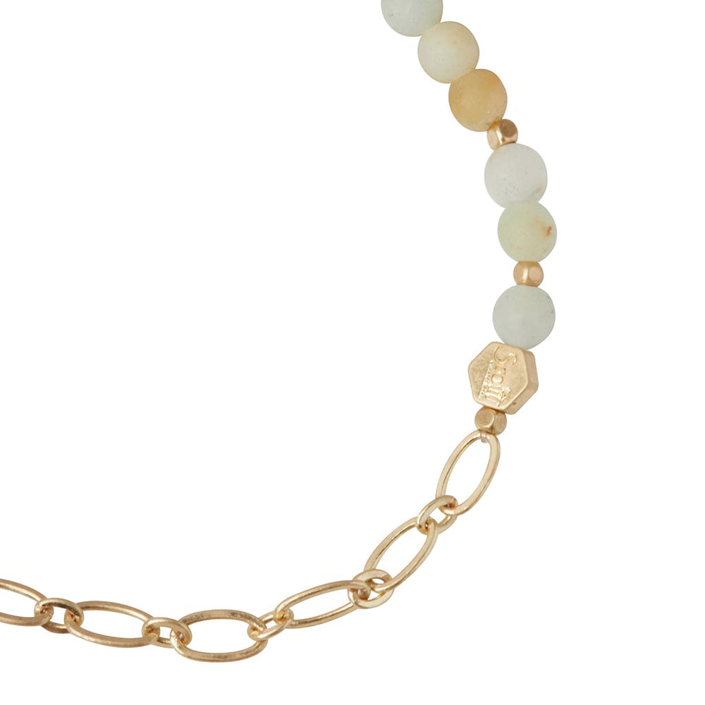 A close-up of the Chain Bracelet Amazonite/Gold by Scout Jewelry, showcasing a transition from a gold paperclip chain to round, light-colored amazonite beads, highlighted by a hexagonal gold bead at the junction.