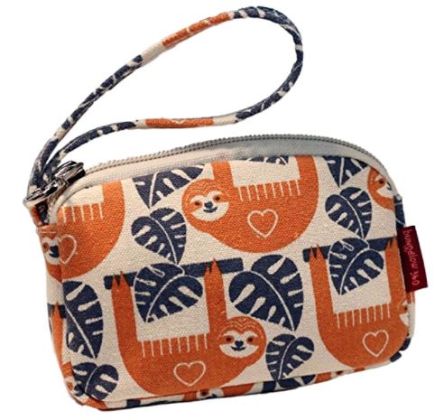 The Tiny Wristlet Sloth by Bungalow 360 is a small zippered pouch made from durable natural cotton canvas. It features a charming fabric design with orange and white sloths hanging from blue and navy leaves. The pouch comes with a matching fabric wrist strap and a red tag on the side, making it the perfect vegan accessory for those who cherish unique, one-of-a-kind patterns.