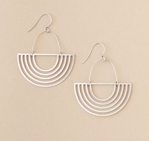 As a highlight of Scout Jewelry's Solar Rays Silver collection, these earrings feature a hook design adorned with multiple concentric half-circles for a sophisticated layered geometric appearance. Crafted from 925 sterling silver, they are hypoallergenic, ensuring both comfort and elegance against a beige backdrop.