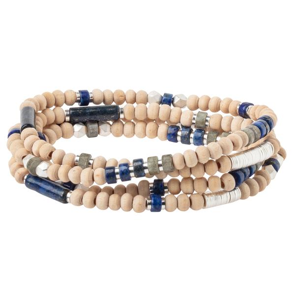 The Lapis/Silverd Stone of Truth set by Scout Jewelry includes three coiled beaded bracelets featuring renewable wood, blue, silver, and metallic gray beads, creating a layered texture with earthy elegance.