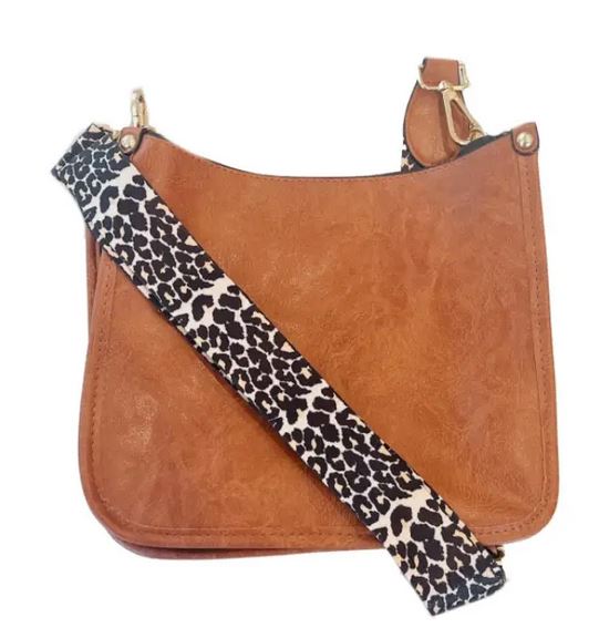 The Sydney Crossbody - Brown by zzzLivFoxy is a stylish vegan leather bag featuring a leopard print strap and gold hardware, elegantly displayed against a white background.