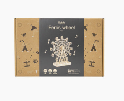 A product packaging box labeled "DIY Ferris Wheel" from Hands Craft, featuring an image of a wooden Ferris wheel model. The box is brown with black accents and displays miniature illustrations and icons related to amusement parks and music. Made from laser-cut plywood, it's a kid-safe wooden puzzle suitable for all ages.