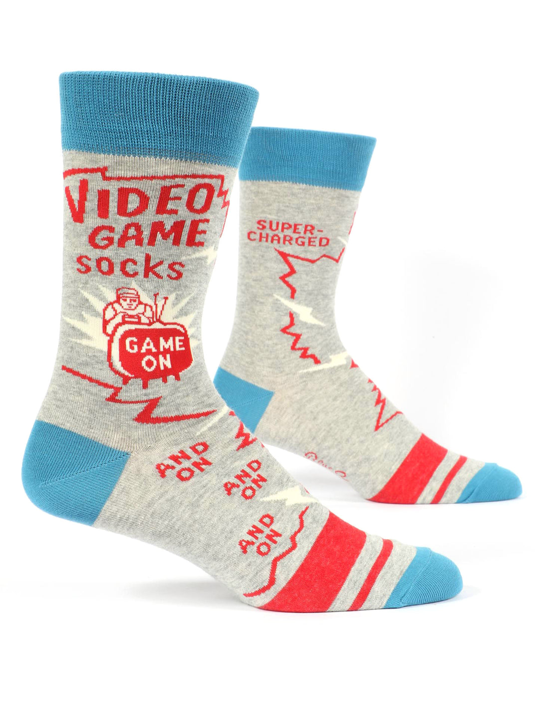 A pair of Blue Q's Video Game Socks in light gray, adorned with blue toes, heels, and cuffs. These socks feature red text and graphics related to video games, with phrases like "VIDEO GAME SOCKS," "SUPER-CHARGED," "GAME ON," and "AND ON AND ON." Red lightning bolt designs are scattered across the fabric. Fits men's shoe size 7-12.