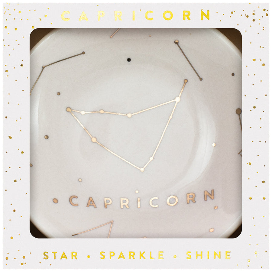 Presenting the Dish Capricorn by LuckyFeather, this white trinket dish features a stunning gold Capricorn constellation design and "Capricorn" beautifully scripted in gold. It comes packaged in an elegant gift box decorated with gold stars and the words "Star Sparkle Shine," making it an ideal choice for use as a jewelry holder or a celestial keepsake.