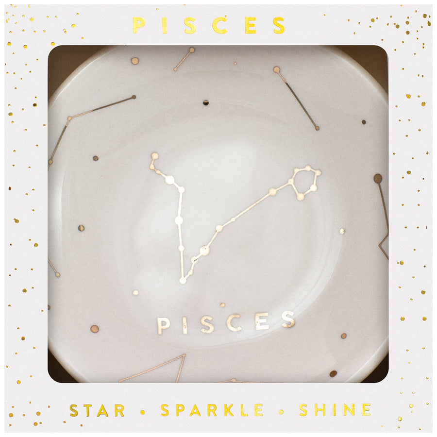 LuckyFeather's Dish Pisces is a white ceramic trinket dish with a central gold Pisces constellation design, accented by small stars. Ideal for holding jewelry, it comes packaged in an elegant gift box featuring the words "Pisces," "Star," "Sparkle," and "Shine" printed beautifully in gold.