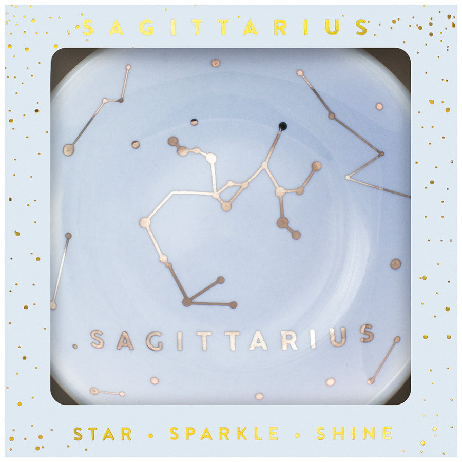 A decorative "Dish Sagittarius" by LuckyFeather, featuring the Sagittarius constellation, is displayed in a light blue box with a starry design. "SAGITTARIUS" in gold letters is printed at the bottom, and "STAR SPARKLE SHINE" is written in gold along the bottom edge of the box.