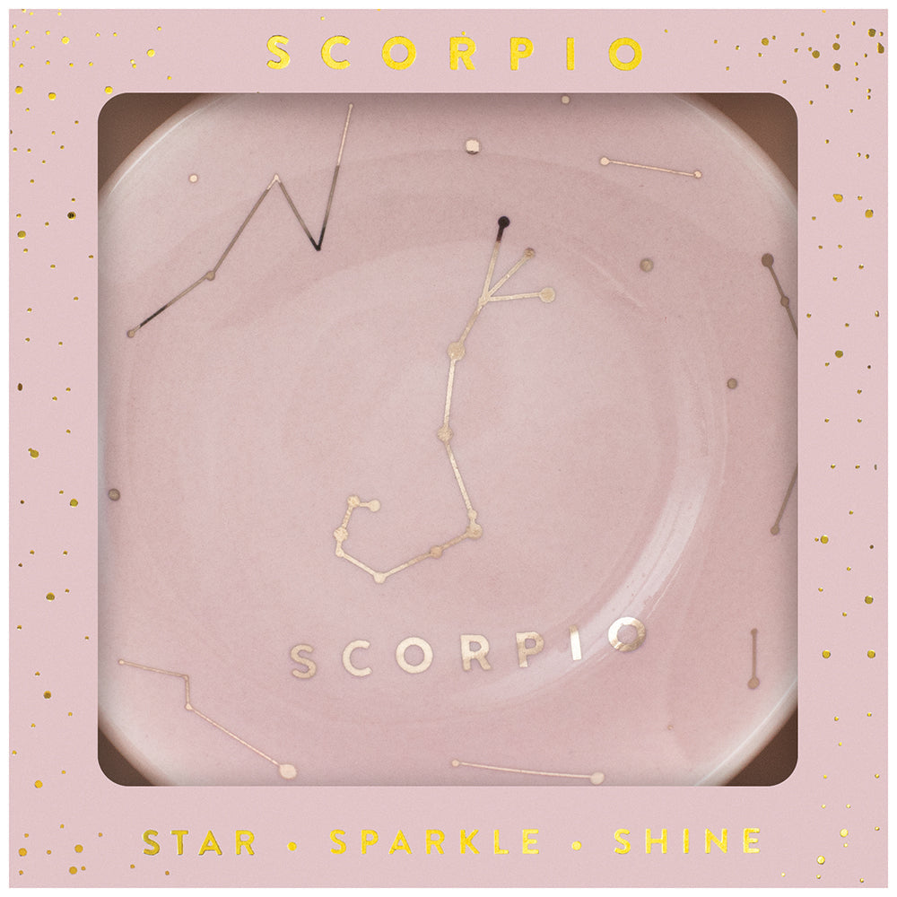 The LuckyFeather Dish Scorpio features the Scorpio constellation on a pink plate embellished with gold accents and "SCORPIO" at its center. The border subtly displays the words "SCORPIO," "STAR," "SPARKLE," and "SHINE" among scattered golden dots, making it ideal for storing jewelry.