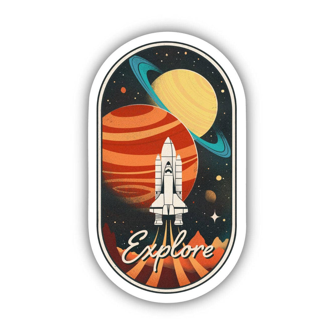 The Explore Space Sticker by Big Moods showcases a retro-themed space illustration with a rocket in the foreground, Saturn with its rings, and a large red planet in the background. The word "Explore" is written at the bottom of this durable design, which is set within an oval frame—making it a perfect and stylish vinyl sticker for any surface.