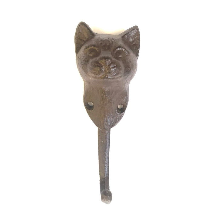 The UPPER DECK Cat Hook is a decorative wall hook crafted from cast iron and designed in the shape of a cat's head, featuring intricate carved facial details. It has a single hook extending from the bottom and boasts a dark, rustic finish. Measuring 6" x 2", it includes two screw holes for easy mounting.