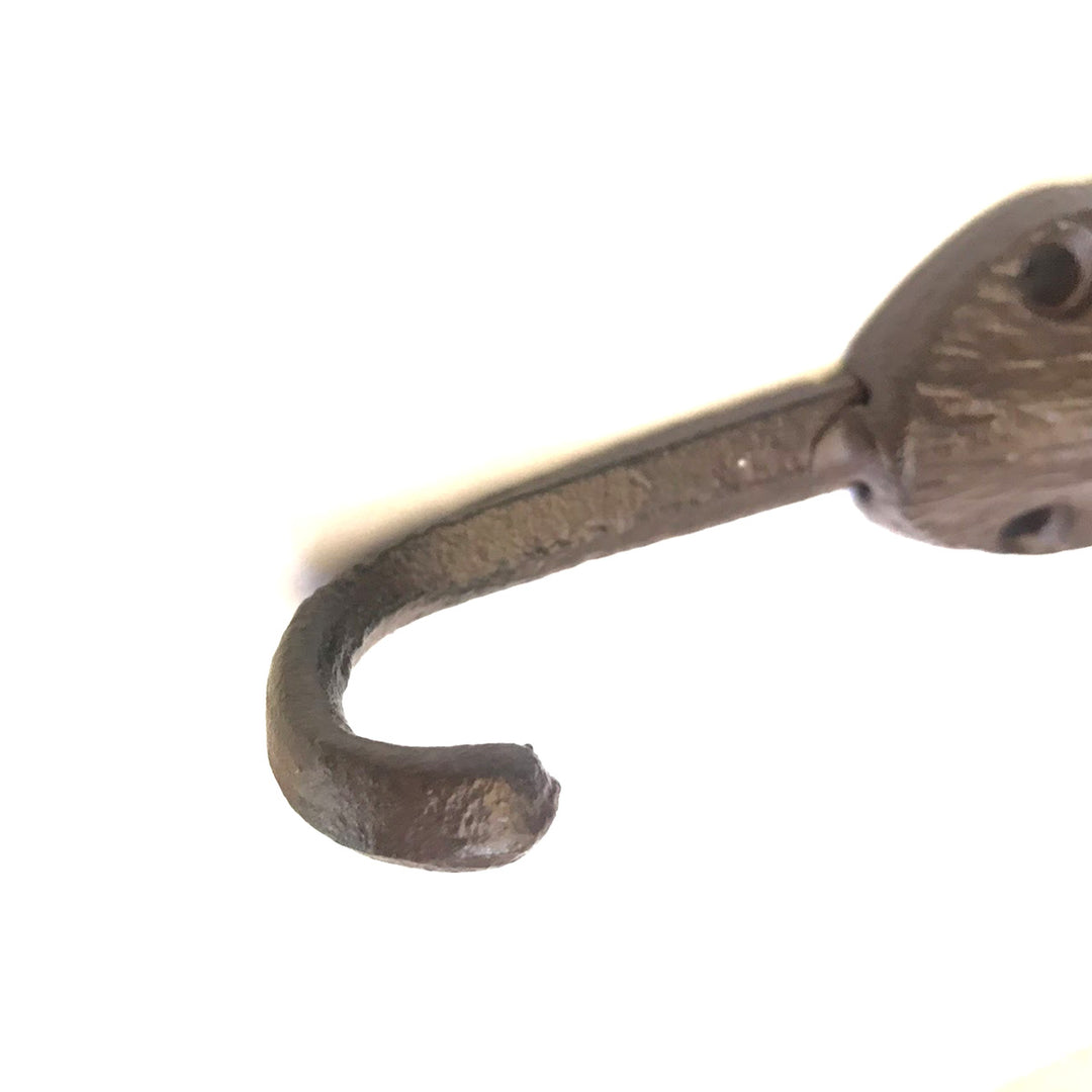 Close-up view of the UPPER DECK Cat Hook in a bronze or dark metallic cast iron finish with a slightly curved end, attached to a rod or handle. Measuring 6" x 2", this hook has some texture and patina, suggesting an aged or vintage aesthetic. It features two screw holes for easy mounting against the plain white background.