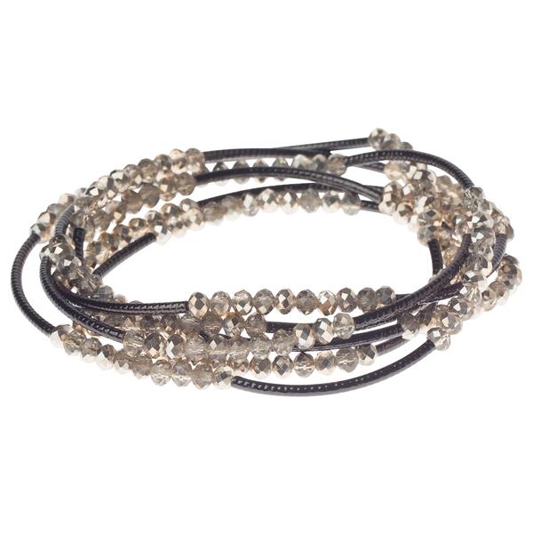 Introducing the "Wrap champagne/hematite - Too Much of Anything" by Scout Jewelry, a beautifully designed multi-strand wrap bracelet. This accessory features dazzling brown and champagne beads that are loosely coiled, with faceted surfaces that capture and reflect light like hematite, creating a stunning shimmering effect. The strands come together seamlessly to form a cohesive and elegant piece perfect for any occasion.