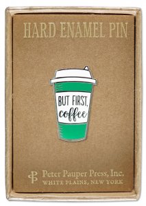 Introducing the "First Coffee Pin" by PeterPauperP: a hard enamel pin featuring a green and white coffee cup with a lid, adorned with the phrase "BUT FIRST, coffee." Perfectly sized for display on a brown cardboard backing highlighted with gold text, this pin is an ideal addition to any gift box that celebrates caffeine love.