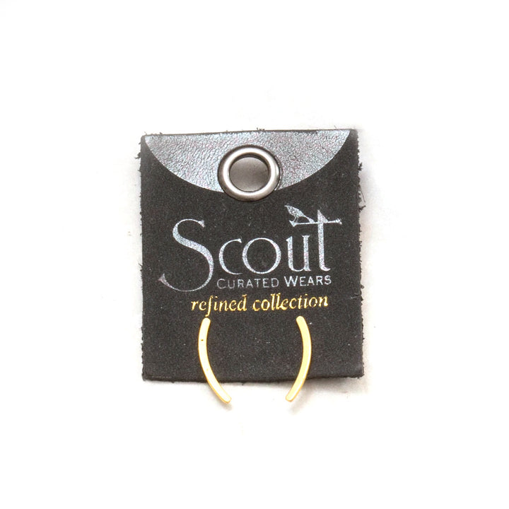 A pair of simple, elegant Comet Curve Gold ear cuffs made from 18k gold vermeil is displayed on a black card with a metal hole for hanging. The card features the "Scout Jewelry" logo and the text "refined collection." The hypoallergenic earrings are crescent-shaped and minimalist in design.