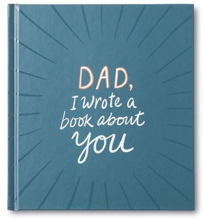 A teal hardcover book titled "Dad I Wrote a Book About You" by Compendium features white and orange text on the front cover, accentuated with radiating lines for a decorative touch. This heartfelt gift book makes for a unique Father's Day present.