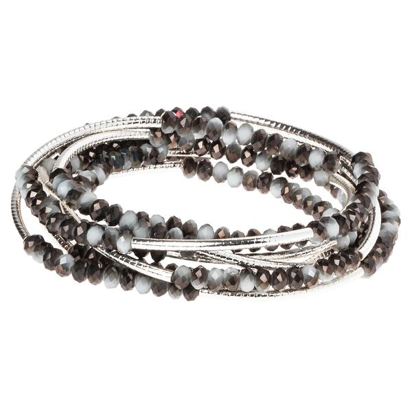 The Wrap Eclipse/Silver bracelet by Scout Jewelry features layers of iridescent black, brown, and white beads intertwined with thin metallic silver strands, forming an elegant spiral pattern similar to a Scout Wrap.