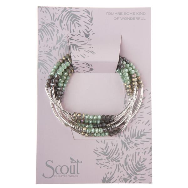 A multi-strand Scout Jewelry Wrap bracelet, named "Iced Mint/Silver - You are some kind of wonder," features green and brown crystal beads elegantly arranged on a card. The card, adorned with a subtle leaf pattern, reads "YOU ARE SOME KIND OF WONDERFUL," with the brand name "Scout Jewelry" proudly printed at the bottom.